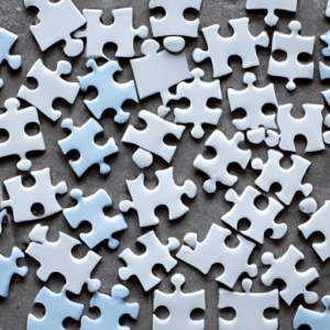 A group of blue and white jigsaw puzzle pieces.